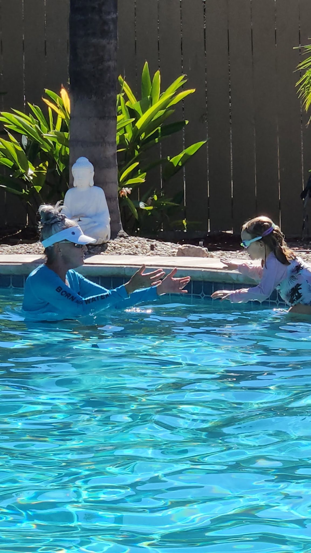 Deanna Birch teaching a young swimmer in her backyard pool